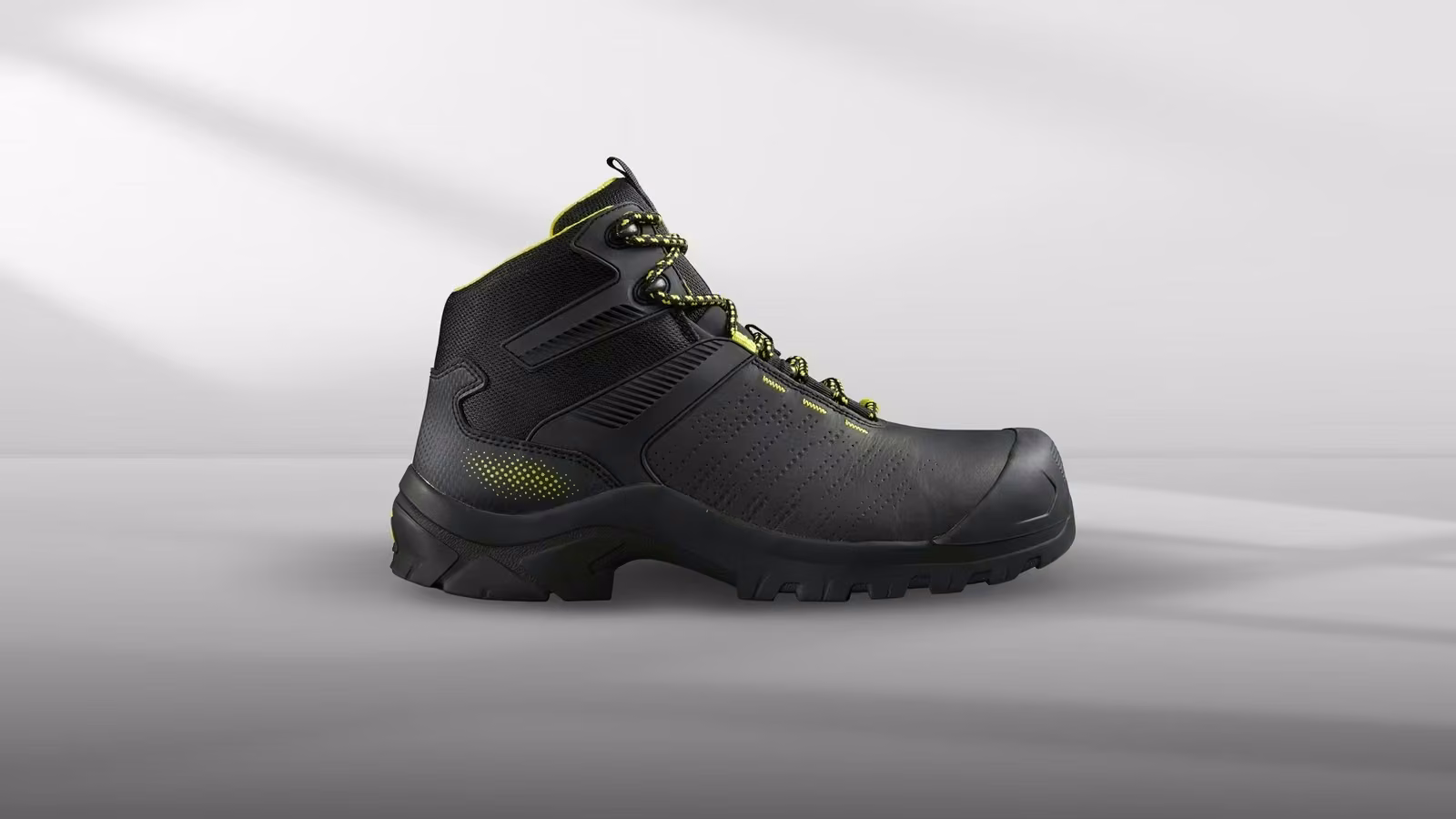 Black and yellow high-top safety boots with reinforced toe and textured design.
