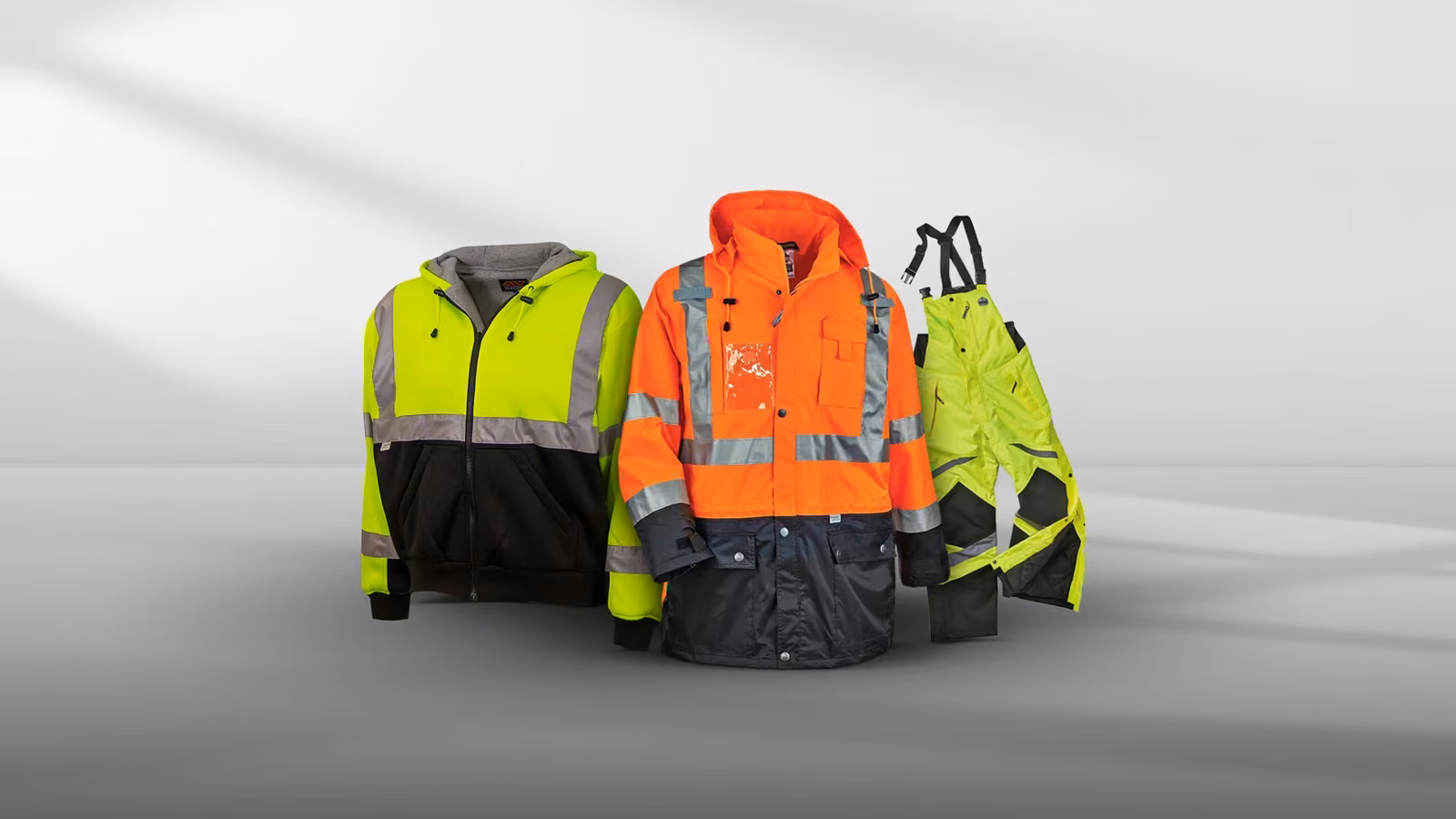 Three high-visibility jackets in various colors: yellow, orange, and a yellow/black mix.