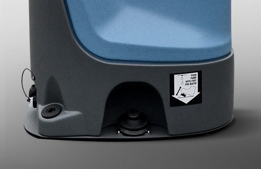 Close-up of a blue and gray portable restroom with a drain and warning label on the side.