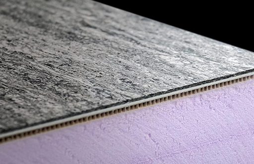 Close-up of a textured black surface with a layered purple core, showcasing material composition.