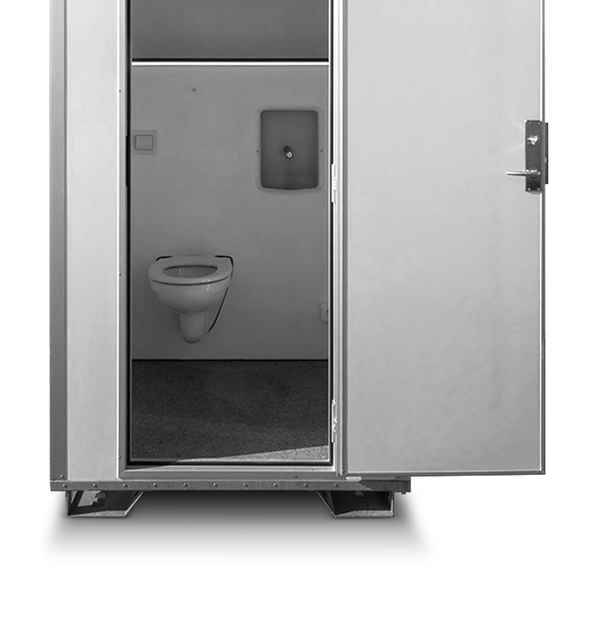 A portable restroom with a toilet and a handwashing station inside. Door partially open.