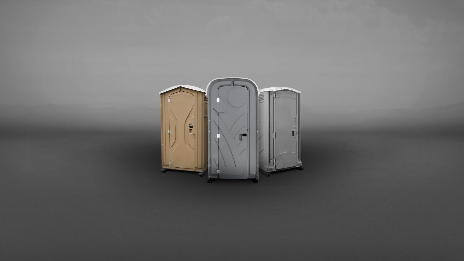 A group of portable toilets in various colors—orange, blue, gray—arranged in a semi-circle.
